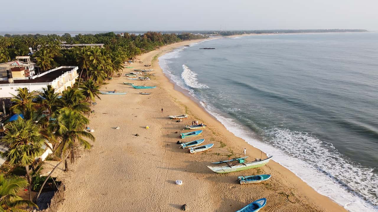 Aerial view of the beach at Arugam Bay with fishing boats on the sand