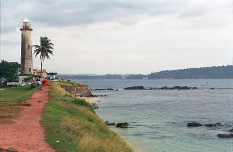 Galle lighthouse beside the old fort ramparts and the sea