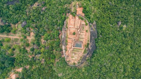 Aerial view of the Sigiriya rock fortress surrounded by forest